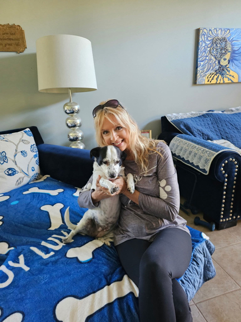 Donna with a happy dog during an in-home pet care visit in Clermont, FL